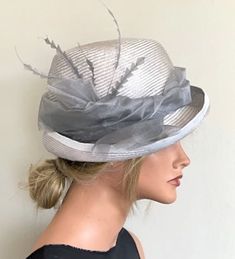 "AWARD MILLINERY DESIGN This striking ice gray parisisal straw hat is soft and comfortable. Parasisal is the finest most expensive straw there is and it takes a master weaver 7 days to weave one piece by hand. Then it took me 3 days to dye. dry, steam, block, shape, size and trim. One-of-a-kind. Head measurement 22\"-22.5\".  Measure 1/4\" above your ears and around where a hat would rest snugly, to be sure this hat will fit you, as hats are not returnable. Made in my millinery studio in the Hol Gray Brimmed Fedora For Spring, Gray Short Brim Fedora For Spring, Fitted Gray Summer Hat, Gatsby Style Summer Evening Hats, Summer Evening Gatsby Style Hats, Summer Evening Gatsby Hats, Elegant Brimmed Fedora For Garden Party, Elegant Fedora For Garden Party, Gray Brimmed Hat For Kentucky Derby