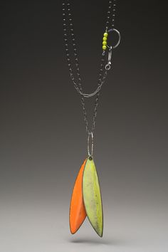 Enamel Necklace - This organically-themed necklace displays hand-formed elongated leaves swiveling on a sterling oval ring. The artists torch-fired enameling technique adds color and varied surface to each distinctive leaf. This pendant hangs from a fully adjustable, oxidized paper clip chain with a bead accent and hand-forged hook closure. Torch Fired Enamel Jewelry, Necklace Displays, Pebble Jewelry, Enamel Necklaces, Oval Rings, Leaf Pendant, Hand Forged, Enamel Jewelry, Paper Clip