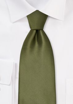 This fresh olive-hued item is a break from the typical solid-color neckties, and it is great for obtaining an elegant degree of confidence and poise in any scenario, whether it be for business or for fun. Earthy colors are ideal for retaining that sense of mental warmth from the heady days of summer into the drab hours of winter, and that is exactly what will occur if you pair this necktie with a suit of complementary earth tones, such as brown, grey, or dark blue, and a white dress shirt with a Black Suit Olive Green Tie, Elegant Green Formal Neckwear, Elegant Solid Color Ties For Work, Elegant Ties For Work, Classic Green Ties For Formal Occasions, Classic Green Neckwear For Business, Classic Solid Ties For Work, Classic Green Formal Tie, Classic Solid Ties For Workwear