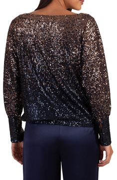 Take your look to glam new heights with this dolman-sleeve top covered in shimmery sequins. Boat neck Long sleeves 95% polyester, 5% spandex Dry clean Imported Festive Long Sleeve Glitter Tops, Glitter Blouse For Night Out In Fall, Glitter Blouse For Night Out, Holiday Evening Tops With Glitter, Fall Glitter Blouse For Night Out, Glamorous Metallic Shimmer Tops, Fall Night Out Glitter Blouse, Metallic Long Sleeve Top With Sequins, Holiday Shimmer Blouse For Night Out