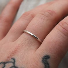 This adjustable hammered sterling silver ring is designed for both men and women who enjoy wearing minimalist style jewelry. This ring is super lightweight and comfortable, making it the perfect everyday wear with any outfit. Stack it or mix and match with other metals. Puffy fingers are no match for this ring! Completely handcrafted by me (Kahlia) in Washington State out of my school bus work studio. Handmade with raw 925 sterling silver wire, this ring is hammered to perfection and polished to Simple Hammered Ring Jewelry, Everyday Adjustable Hammered Stackable Rings, Minimalist Hammered Stackable Rings, Minimalist Hammered Midi Rings For Anniversary, Simple Hammered Stackable Rings As Gift, Simple Hammered Stackable Rings For Gifts, Simple Hammered Stackable Rings For Gift, Simple Hammered Stackable Rings Gift, Minimalist Hammered Silver Stackable Rings