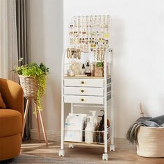 a living room with a chair and a white cabinet filled with items on top of it