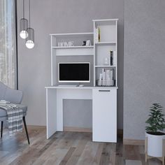 a white computer desk sitting on top of a hard wood floor next to a chair