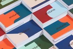 several different colored business cards with the words enquire and an apple on them