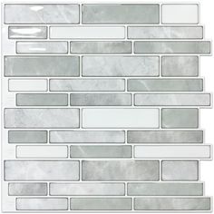 a white and grey tile wall with some gray tiles on it's side,