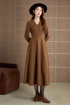 Step into timeless elegance with this vintage-inspired brown dress. Crafted from a smooth, woolen fabric, this mid-length dress features a flattering V-neckline and long sleeves. The flared skirt adds a touch of femininity and movement, making it ideal for both casual outings and special occasions. DETAIL * 30% wool, 30% fiber, 40% polyester * fully satiny lining, more nice to the touch body * Long sleeves dress * Fit and flare dress * Right zipper closure * Two side seam pockets * Belted dress * Mid-calf length dress * Vintage wool dress * Perfect for autumn, winter * Lean More about the items From the FAQs on the page bottom MODEL SIZE Bust 85 cm(33.4") Waist 67 cm(26.7") Height 168cm (5' 6") She wears size XS Choose CUSTOM Order if you * Need a better fit * Can't find your size in our s Midi Dress A Line, Winter Wool Dress, Long Sleeves Dress, Calf Length Dress, Dress Autumn, Dress Long Sleeves, Winter Dress, Sleeves Dress, Mid Dresses