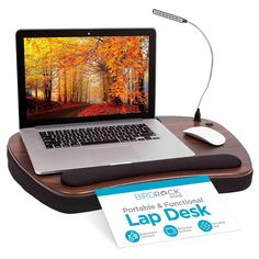 a laptop computer sitting on top of a wooden desk