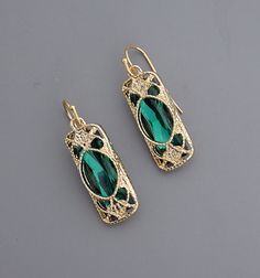 Vintage Jewelry - Emerald Green Drop Earrings - Filigree Earrings - Green Earrings - Gold Earrings - Crystal Earrings - Chloe's Vintage These are such pretty earrings! Lovely drop earrings with a sparkling emerald green crystal at the center surrounded with a filigree design. These earrings are are gold plated. Chloe says."Wear them and feel fabulous!" They measure 1 1/2" long. Thanks for visiting Chloe's Green Formal Earrings With Ear Wire, Green Metal Earrings For Formal Occasions, Green Filigree Drop Earrings, Green Filigree Earrings For Formal Occasions, Green Formal Filigree Earrings, Formal Green Filigree Earrings, Emerald Green Crystal, Jewelry Emerald, Filigree Earrings