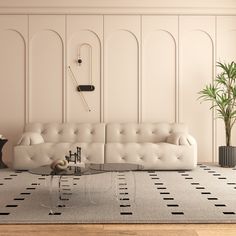 a living room with a couch, coffee table and potted plant on the floor