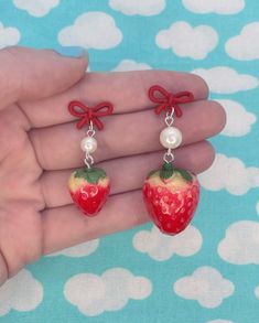 Hello and welcome to my listing for a pair of Retro Strawberry Pearl Bow Tie Pin Up Kitsch Kawaii Dangle Earrings!  These one of a kind earrings are handmade and feature a plastic strawberry charm, a pearl bead, and a red bow tie stud with a metal push back closure. Dimensions Large Strawberry Dangle Length: 5 cm Width: 2 cm Dimensions Small Strawberry Dangle Length: 4 cm Width: 1.5 cm 🍓✨Please avoid wearing this item while showering, sleeping, swimming or exercising to avoid damage. Store jewe Cute Polymer Clay Dangle Earrings, Handmade Red Sweet Earrings, Sweet Red Earrings For Gift, Handmade Red Kawaii Jewelry, Sweet Handmade Earrings For Gift, Sweet Handmade Earrings As Gift, Cute Handmade Drop Earrings, Kawaii Polymer Clay Earrings For Gift, Sweet Handmade Dangle Earrings