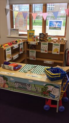 a child's playroom with toys and books on the table in front of it