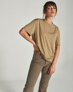 A 4-way stretch lightweight cotton tee that fits oversized. Perfect with biker shorts or tucked in with your favorite pair of joggers or jeans. Details Model is 5'10" and wears a size small. Care: Turn inside out. Machine wash cold on delicate cycle with similar colors. Tumble dry on low. Iron on low if needed. Composition: 57% Cotton | 38% Modal | 5% Spandex | 7DIAMONDS Women's Boyfriend T-Shirt in Khaki | Size Small Versatile Oversized T-shirt For Everyday, Versatile Oversized T-shirt, Khaki Relaxed Fit Tops For Everyday, Jeans Details, Everyday Tote, Boyfriend T Shirt, Boyfriend Tee, Low Iron, Biker Shorts