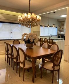 a dining room table with chairs and a chandelier