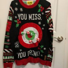 an ugly christmas sweater hanging on a door