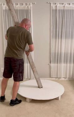 a man standing on top of a white round object