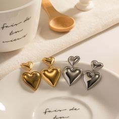 Two-Tone Heartbeats "Bicolor Heart Whispers - Gold and Silver Layered Heart Stud Earrings" represent a perfect melding of taste and fashion with their distinctive bicolor design. Capturing the timeless beauty of the heart shape, the combination of gold and silver hues allows the wearer to shine distinctively. Specifications: Dimensions: 3.22cm Long, 2.03cm Wide Materials: 925 Silver Color: Silver, Gold Metal Heart Earrings For Mother's Day, Mother's Day Metal Heart Earrings, Mother's Day Heart Shaped Metal Earrings, Mother's Day Heart-shaped Metal Earrings, Valentine's Day Double Heart Metal Earrings, Heart Shaped Earrings, Vintage Punk, Heart Stud Earrings, Heart Drop Earrings