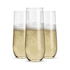 three glasses filled with champagne sitting next to each other