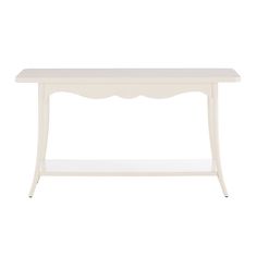 a white table with scalloped legs and a shelf on the bottom that has an open drawer