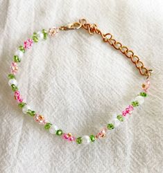 Elevate your wristwear with this exquisite handmade beaded flower bracelet, meticulously crafted to add a touch of natural beauty to your style. Each delicate petal and vibrant bead is expertly woven into a stunning floral design, creating a unique and eye-catching accessory. This floral bracelet is perfect for nature-inspired fashion enthusiasts, boho-chic lovers, or anyone seeking a timeless piece with a touch of artisanal charm. With its intricate beadwork, this bracelet seamlessly blends ele Dainty Beaded Flower Crystal Bracelet, Dainty Pink Beaded Chain Bracelet, Dainty Flower-shaped Beaded Crystal Bracelet, Delicate Beaded Crystal Bracelet With Round Beads, Pink Beaded Flower Crystal Bracelet, Dainty Handmade Crystal Bracelet With Round Beads, Pink Flower-shaped Beaded Crystal Bracelet, Handmade Pink Crystal Dainty Bracelet, Handmade Pink Dainty Crystal Bracelet