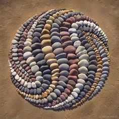 a circular rug made out of rocks on the ground