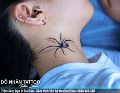 a woman with a spider tattoo on her neck