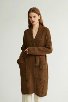 Elevate Your Look with the Ultimate in Wool Comfort and Style Revel in the timeless charm of our Casual Wool Belted Duster Cardigan. Crafted from 100% wool, this piece ensures a luxuriously soft, cashmere-like feel. Its high moisture-wicking and excellent elasticity keep you comfortable and dry, while its thick knit design offers superb warmth. Style-wise, it exudes a serene, age-reducing aura with its collarless design and stretchy fabric. The loose fit and medium length make it versatile for a Luxury V-neck Fall Outerwear, Long Brown Cardigan For Workwear, Long Brown Cardigan For Work, Elegant Fall Sweater For Daywear, Elegant Brown Sweater Coat For Spring, Elegant Wool Cardigan With Shawl Collar, Elegant Brown Sweater For Winter, Elegant Long-sleeved Merino Wool Sweater Coat, Elegant Long Sleeve Merino Wool Sweater Coat