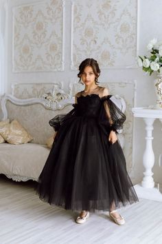 The Anaya Girls Pageant Dress is the epitome of elegance and style, designed to make your little girl shine on all special occasions. Its lightly sequined satin bodice with a sheer neckline adds a touch of sparkle and sophistication, ensuring she stands out in the crowd. The detachable sheer sleeves offer versatility and comfort, allowing for a customizable look that can adapt to any event. The back of the dress features a sheer deep V neckline, accented with a gorgeous oversized bow, which adds Princess Style Dress With Sheer Bodice For Pageant, Princess Style Pageant Dress With Sheer Bodice, First Communion Ball Gown With Lace Bodice For Party, Lace Bodice Pageant Dress For Party And Prom Season, Lace Bodice Pageant Dress For Party During Prom Season, Party Princess Dress With Lace Bodice, Elegant Ball Gown For First Communion Party, Tulle Princess Dress With Lace Bodice For Party, Party Princess Dress With Lace Bodice And Tulle