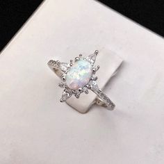 White Fire Opal Sterling Silver Ring, Cabochon Opal Ring, Fire Opal Engagement Ring, White Opal, Minimalistic Ring, Stacking Ring, Promise Ring 💎 Gemstone: Conflict-free Cabochon Fire-Opal (Origin Mexico) 💎 Base Material: Solid Sterling Silver (925) 💎 Additional Material: Rhodium (Precious Metal) 💎 Stamps / Markings: 925 After-Sale Services: 💎 30 Days No Quibble Return or Exchange 💎 Guarantee: 90 Days Free Repairing ( Free Exchange if necessary) 💎 Warranty: Lifetime Free Polishing and Cle White Diamond Crystal Ring With Oval Shape, White Oval Cabochon Promise Ring, Anniversary Cabochon Diamond Ring, White Oval Crystal Ring With Halo Setting, Silver Opal Rings With Center Stone, White Opal Cabochon Ring For Promise, Silver Opal Ring With Halo For Anniversary, White Opal Cabochon Promise Ring, White Cabochon Opal Promise Ring