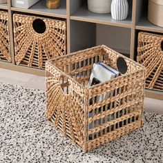 two wicker baskets sitting on top of a rug next to a book shelf filled with books