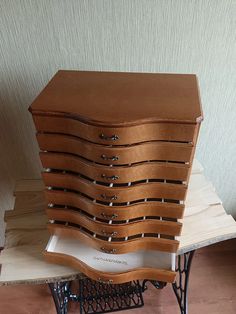 a stack of wooden drawers sitting on top of a table