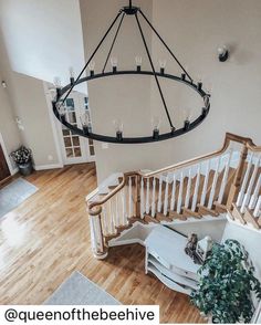 an overhead view of a spiral staircase in a house with wood floors and white railings