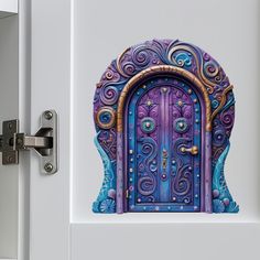 an image of a door that is painted on the side of a building with blue and purple colors