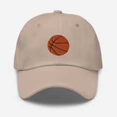 Show off your love for basketball with our embroidered Dad Hat! Sporty yet stylish, this cap is perfect for both men and women. A great gift for any basketball fan, it features an adjustable fit for ultimate comfort. Score big on style with this ball cap that's as authentic as your passion for the game!  Dad hats aren't just for dads. This one's got a low profile with an adjustable strap and curved visor. * 100% chino cotton twill * Green Camo color is 35% chino cotton twill, 65% polyester * Unstructured, 6-panel, low-profile * 6 embroidered eyelets * 3 ⅛" (7.6 cm) crown * Adjustable strap with antique buckle * Blank product sourced from Vietnam or Bangladesh Embroidered Logo Snapback Dad Hat For Game Day, Game Day Embroidered Logo Snapback Dad Hat, Game Day Snapback Dad Hat With Embroidered Logo, Streetwear Cap With Cotton Sweatband, Streetwear Snapback Hat With Cotton Sweatband, Game Day Embroidered Logo Dad Hat, Game Day Dad Hat With Embroidered Logo, Sports Fan Baseball Cap For Baseball Season Streetwear, Sports Fan Baseball Cap For Streetwear During Baseball Season