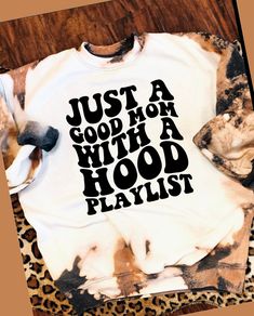 a t - shirt that says just a good mom with a hood playlist on it