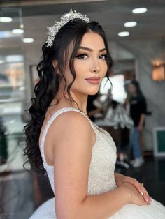 a woman in a wedding dress posing for the camera