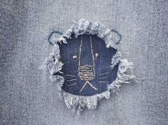 an animal made out of jeans with some holes in it's back pocket and eyes