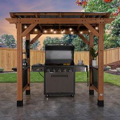 an outdoor bbq grill with lights on it and a table in the back ground