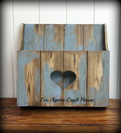 an old wooden box with a heart cut out in the middle and words on it