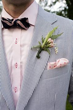 a man wearing a striped suit and bow tie