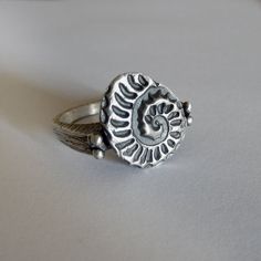 The ring is textured and oxidized, and have a modern, minimal contemporary design but a classic theme. ► MEASUREMENTS: I gave the ring a dark patina and then polished to a matte finish, except the top which is polished less to stand out. Ammonite size approx. 15 x 12 mm Ring total height: 2.4 cm The ring in the photos is ready to ship in 7.5 US size, but I can make this ring in any size you need. If the ring will be made to order, please allow 7 days after your payment. ►Please be sure of your r Modern Rings With Oxidized Finish For Gifts, Adjustable Stackable Rings With Oxidized Finish, Adjustable Stackable Rings With Oxidized Finish As Gift, Adjustable Oxidized Stackable Rings As Gift, Oxidized Sterling Silver Stackable Rings, Fossil Ring, Minimal Contemporary, Clean Sterling Silver, Celtic Wedding Rings