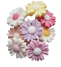 small plastic flowers in pastel colors on a white background