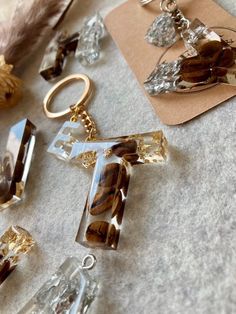 several pieces of jewelry laying on top of a table next to a feather ornament