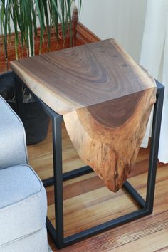 a wooden table sitting on top of a hard wood floor next to a blue couch