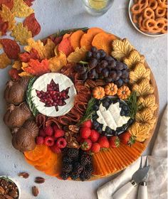 a platter filled with fruit and nuts