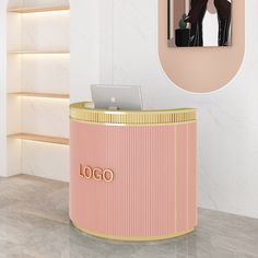 a pink and gold desk with a laptop on it next to a photo of a woman