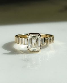 an emerald cut diamond engagement ring with baguets