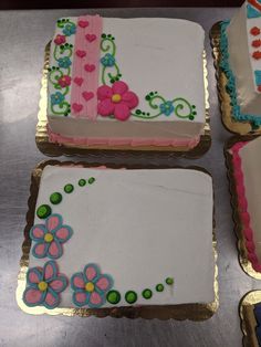 four decorated cakes sitting on top of a table