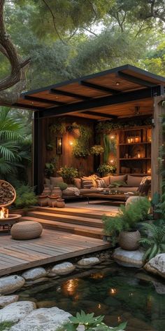 an outdoor living area with water and rocks