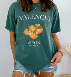 Valencia Spain Oranges Tee Shirt, Cute Unisex Espana Tshirt The Comfort Colors C1717 100% Ring Spun Cotton T-Shirt is very appropriately-named. All colors are inspired by nature and have a perfect lived-in, weathered look. Shirts are sent through a unique dyeing process that makes them incredibly soft and long-lasting. Each piece is soft-washed 50 times before making its way to you! Stitched at the collar, armhole, sleeves and bottom hem for ultimate durability, you will notice the density and q Green Logo Print T-shirt For Spring, Casual Branded Summer T-shirt, Casual Branded T-shirt For Summer, Casual Summer T-shirt With Branding, Vintage Cotton T-shirt With Branding, Orange Letter Print T-shirt For Spring, Vintage Cotton Top With Branding, Green Summer Shirt With Slogan, Green Short Sleeve Shirt With Logo Print