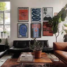 a living room filled with furniture and pictures on the wall above it's coffee table